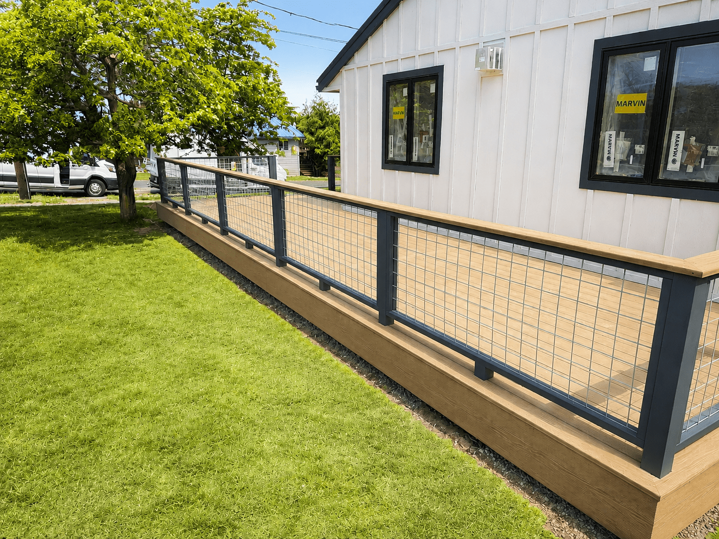 Custom Composite Deck with Modern Railing Custom composite deck featuring modern powder-coated railing and premium outdoor living space in Coupeville, Washington.